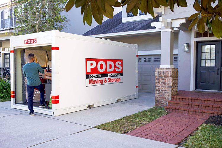 A man loads his PODS container, getting ready for his move to Arlington