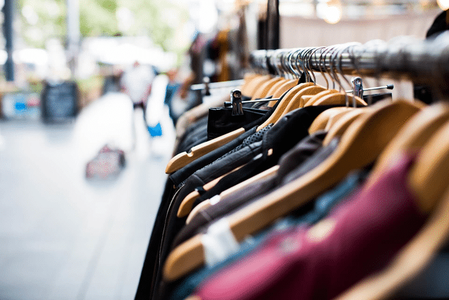 Rack of clothing with merchandise at an outdoor pop-up shop setting