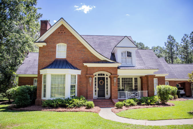 A split-level brick home with Tudor-style elements, similar to those in Riverbend — one of the best Baton Rouge neighborhoods.
