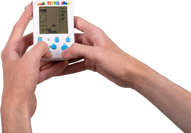 A pair of hands playing Tetris on a Tetris keychain