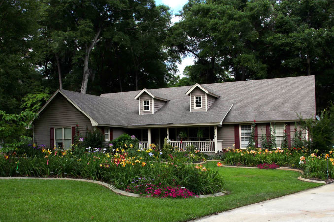 A beautiful, one-story home with a covered front porch and landscaped lawn in Coffee Bluff — one of the safest neighborhoods in Savannah, GA.