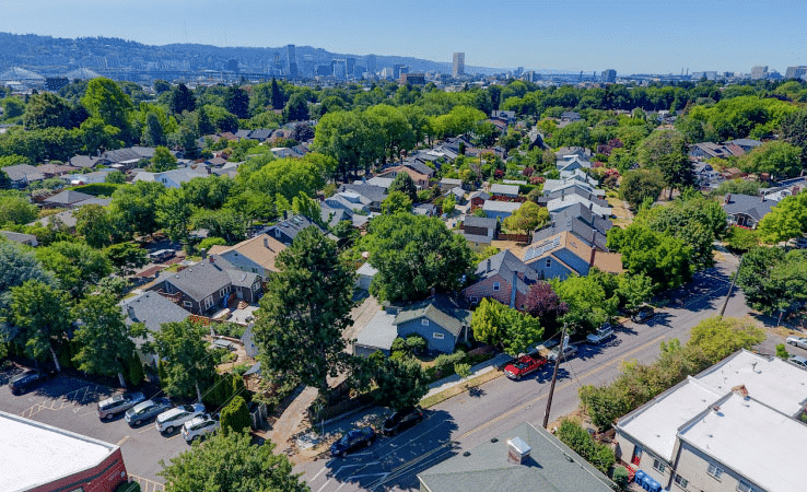 Aerial springtime view of the popular Ladd’s Addition neighborhood in Portland, Oregon, featuring many mature trees and diagonally angled residential streets. 