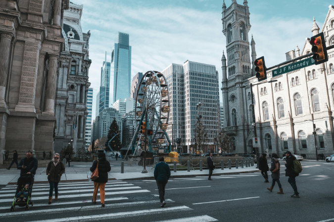 People walk across a street in Philadelphia, one of the most walkable cities in the U.S.