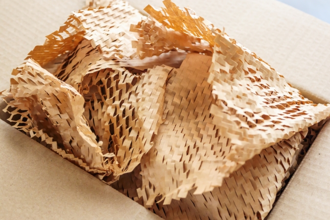 A box filled with honeycomb packing paper, which is one of the best packing materials for fragile items that’s also eco-friendly.