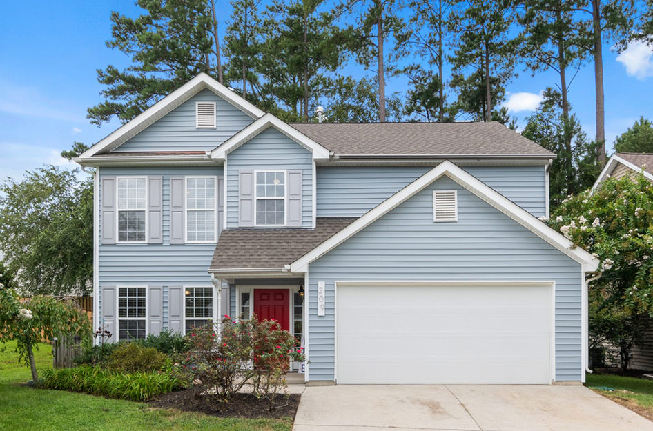 blue house with large garage door