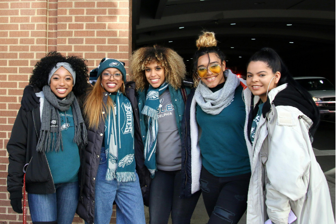Five friends pose for a picture while on their way to watch the Philadelphia Eagles play.