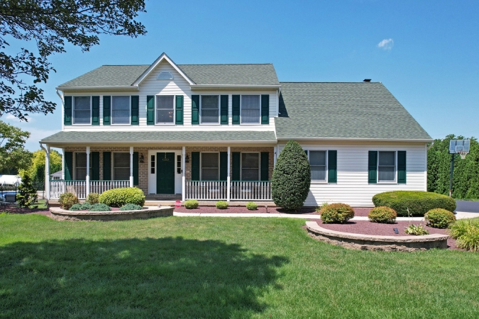 A well-maintained, split-level suburban home found in Bethlehem Township — one of the best Bethlehem neighborhoods — featuring a manicured lawn, landscaped garden beds, and a covered front porch.