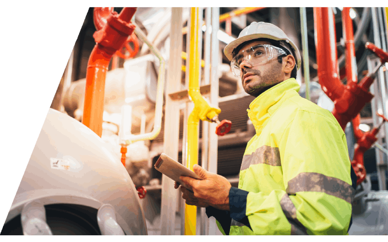 technician operating a hoist using a handheld remote