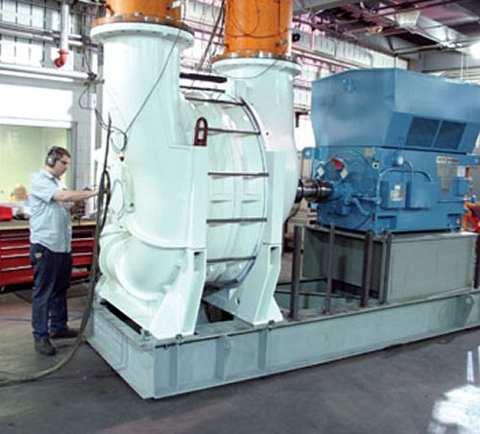 field service operator working on large vacuum blower