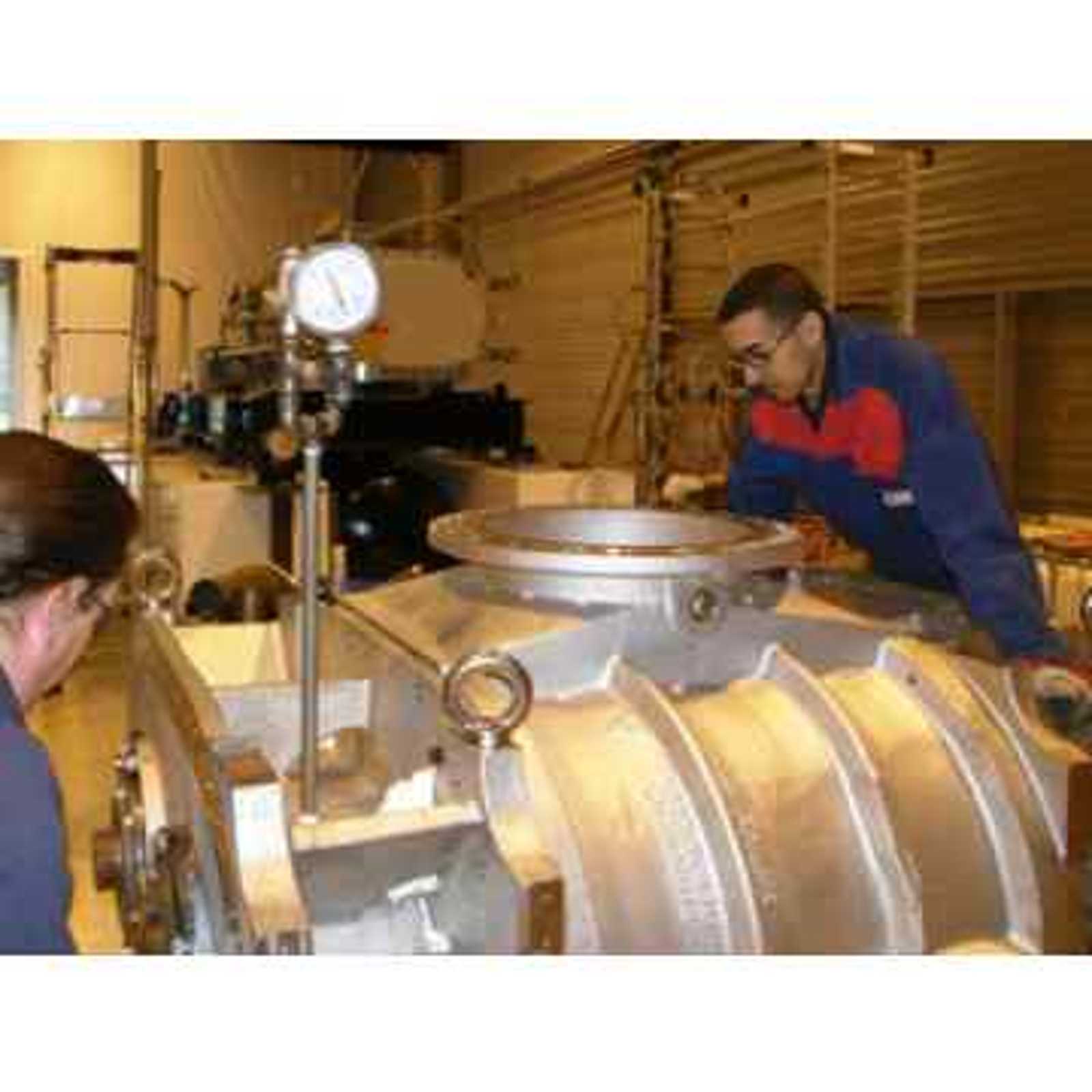 Hibon after-sales service workers repairing large rotary piston process blowers dedicated to the nuclear industry.