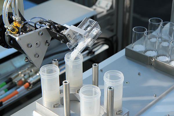 Robot with tilting glass vial with powder