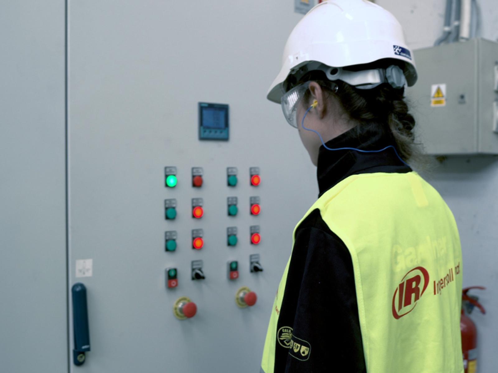 A person wearing a hard hat and safety goggles