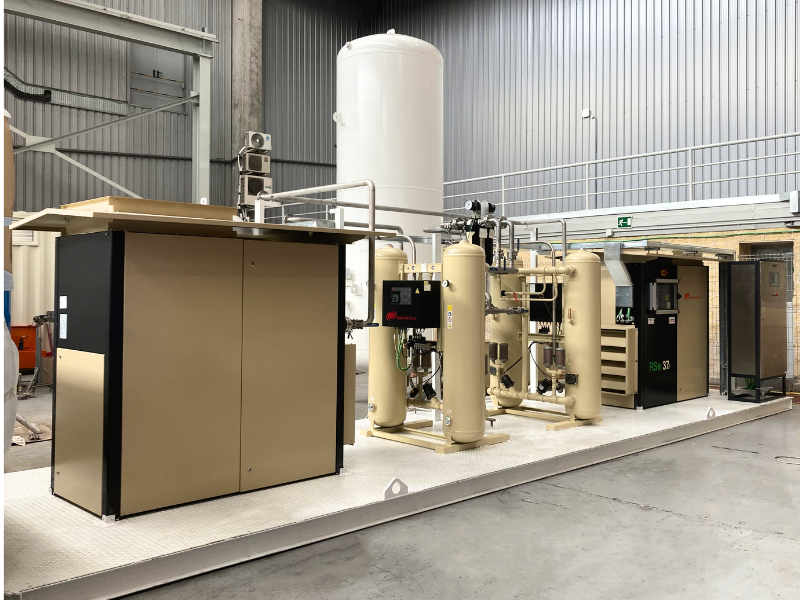 A large ingersoll rand air compressor machine in a factory