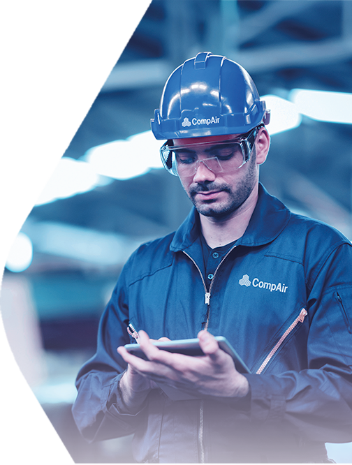 Industrial technician using tablet for compressor monitoring