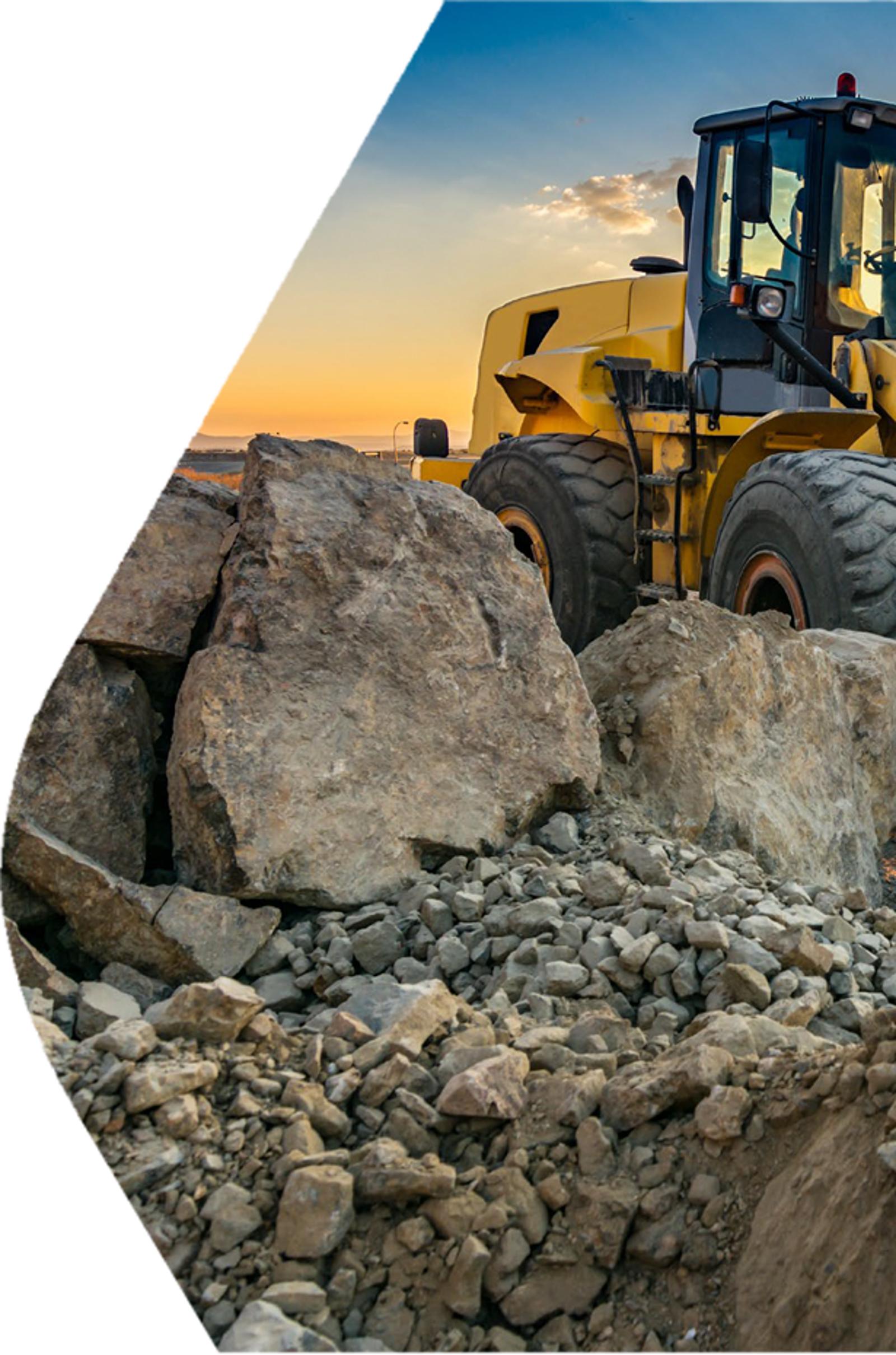 Mining loader moving rock in open-pit site