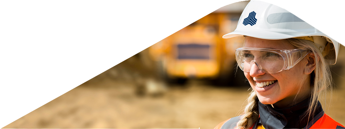 Mining professional with safety gear at open-pit site