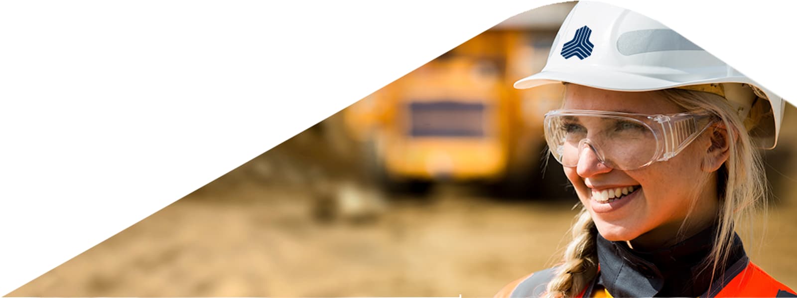 Mining professional with safety gear at open-pit site