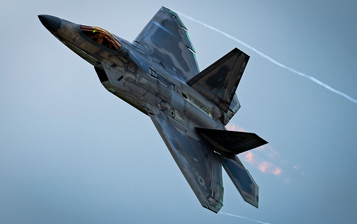 Military aircraft flying at high speed in the sky