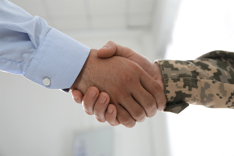 Handshake between a civilian and a military personnel.