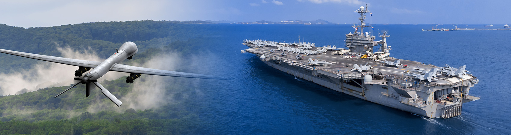 Military drone in flight alongside an aircraft carrier operating at sea