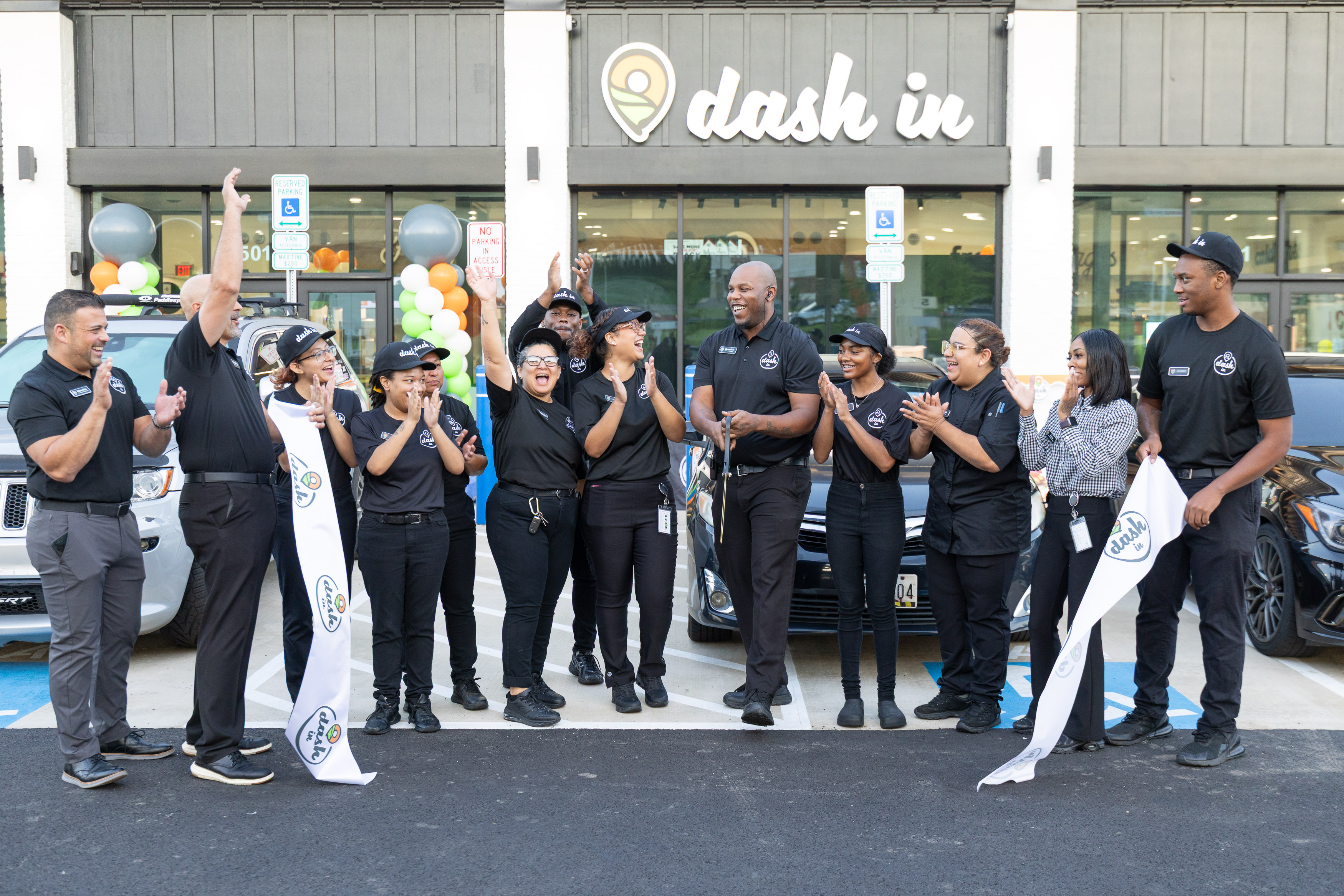 Dash In and Splash In welcome guests to new location in Upper Marlboro, MD, with a ribbon cutting, giveaways, community donations, and golden tumbler giveaways..jpg