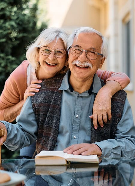 Elderly couple hugging