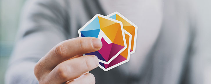 Man holding die-cut single logo stickers