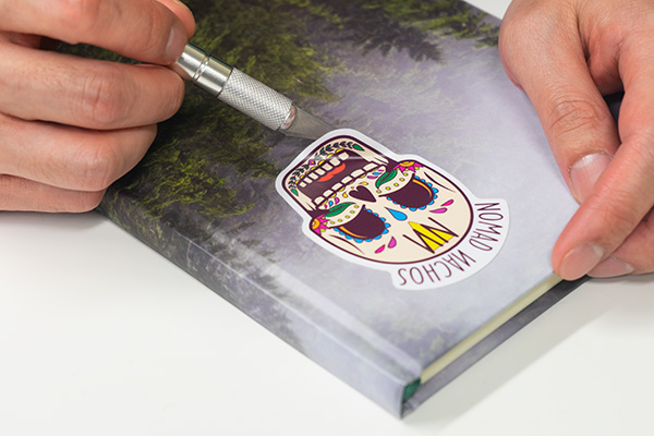 How to remove stickers from books with a razor blade.