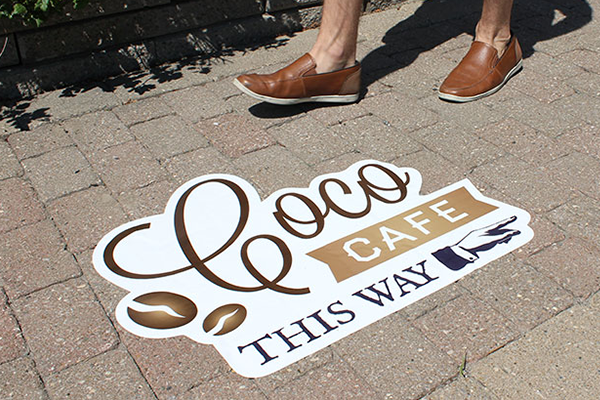 Street decal pointing direction to storefront