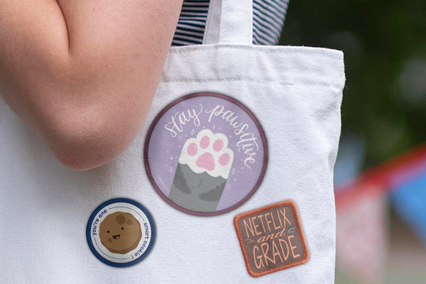 A tote bag featuring various different patches.