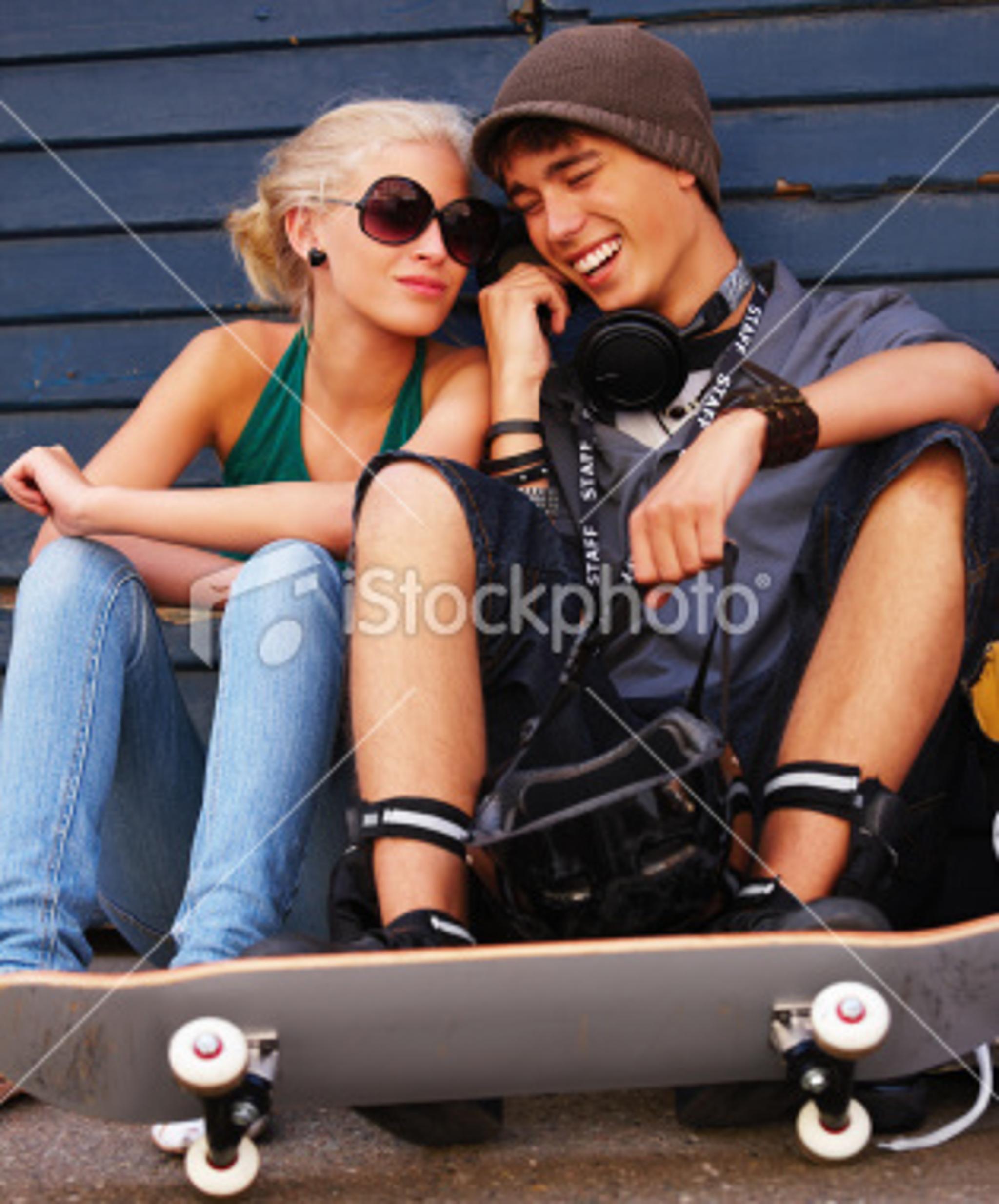 ist2_6760926-happy-teenage-couple-sitting-together-on-street-with-skateboard.jpg