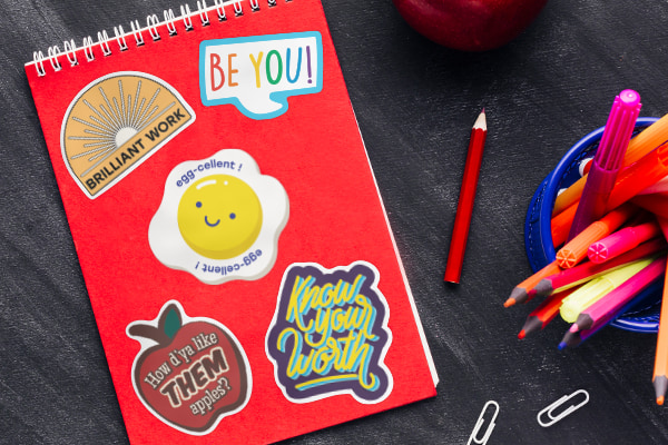 A notebook with various different stickers applied.