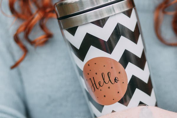 Metal water bottle with a cute sticker on it.