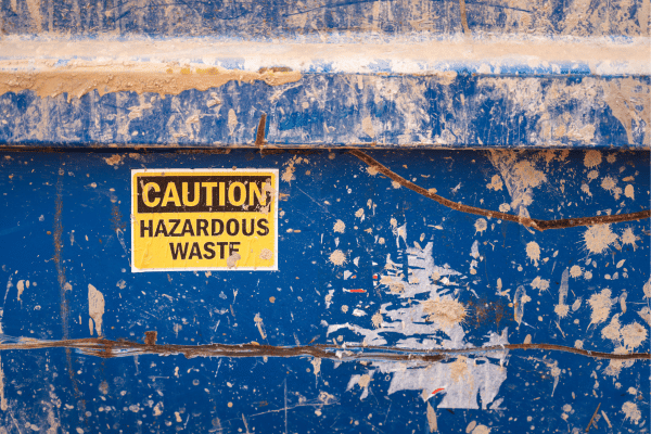 A damaged water-resistant sticker showing signs of wear and tear due to exposure to severe weather conditions.