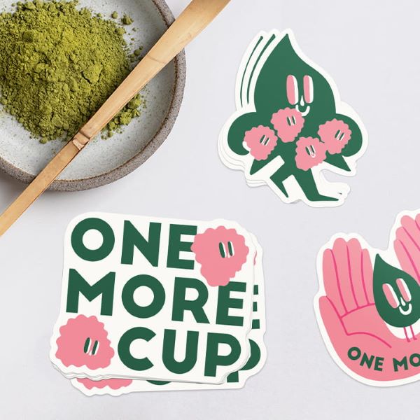 A stack of Vinyl Alternative stickers.