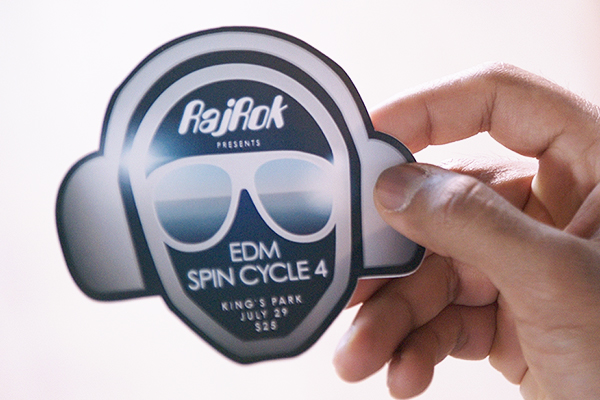 Man holding a die-cut single sticker of a company logo