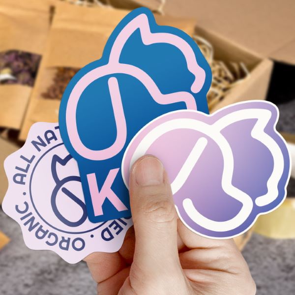 Vinyl Alternative stickers fanned out in a hand.