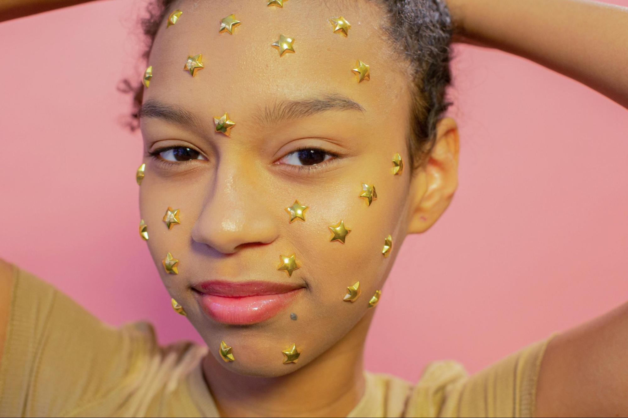 Girl wearing star-shaped face stickers