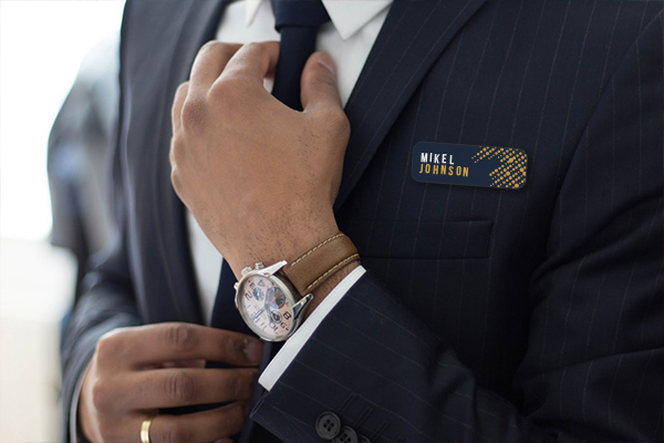 A person networking and wearing a badge