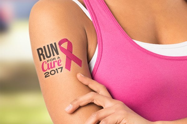 Man holding a die-cut single sticker of a company logo