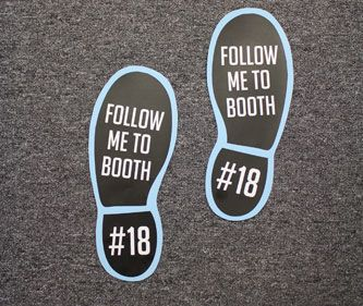 Man holding a die-cut single sticker of a company logo