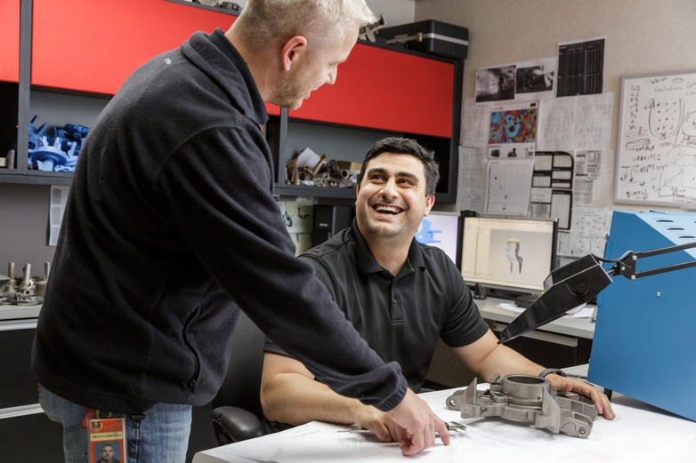 Two engineers discussing an investment casted part