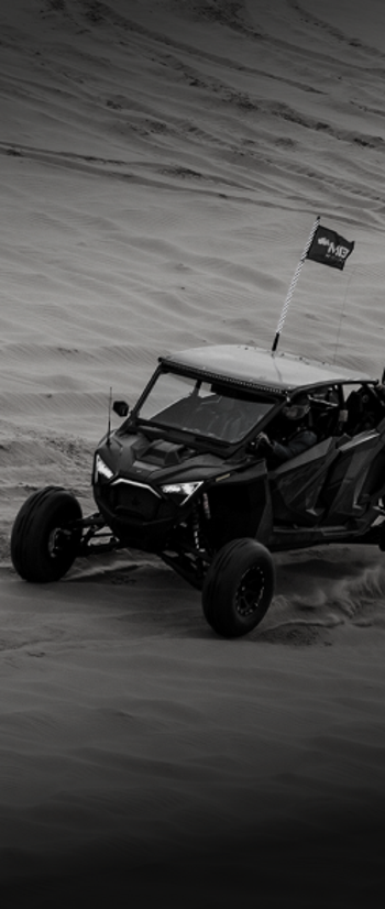 Recreational vehicle driving on a sand dune