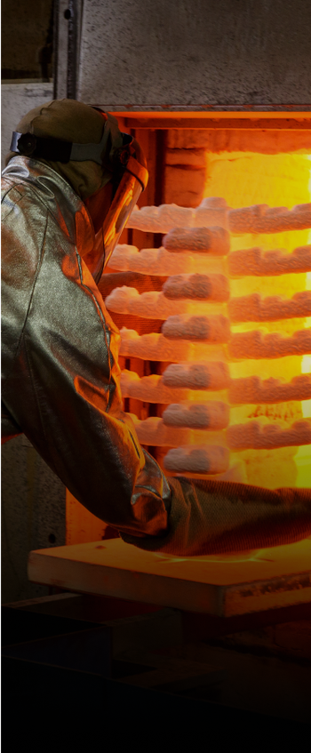 Man putting in ceramic investment castings to an oven