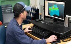 Die casting engineer inspecting 3D CAD files on a computer