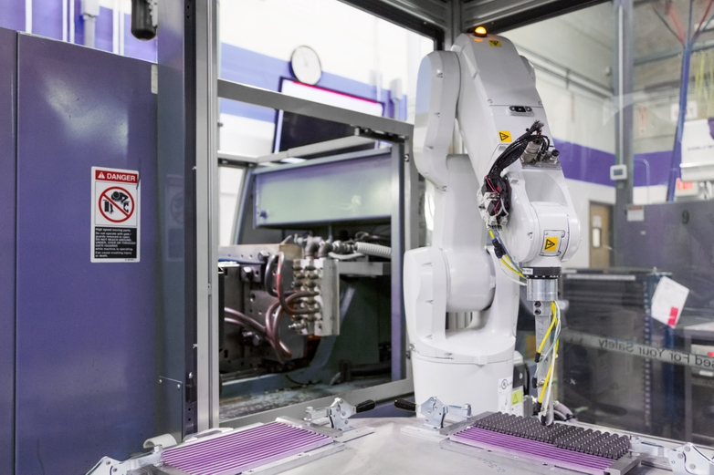 Robot arm moving metal injection molding parts