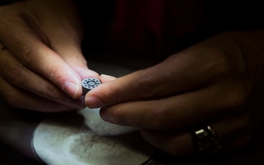 Engineer inspecting a metal injection molding part