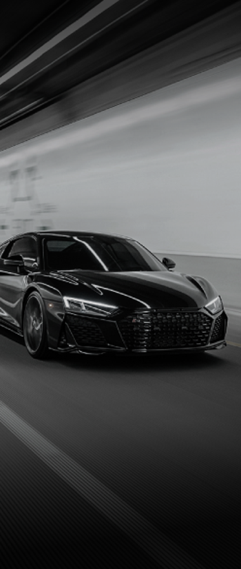 Black sports car driving in a tunnel