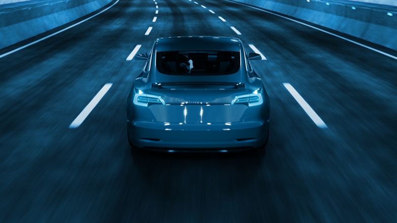 Car driving through a tunnel at night