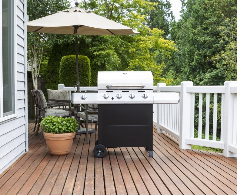 Stainless steel grill on a house deck